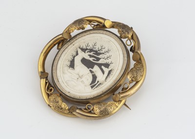 Lot 184 - A 19th Century pinchbeck carved antler and photographic revolving brooch