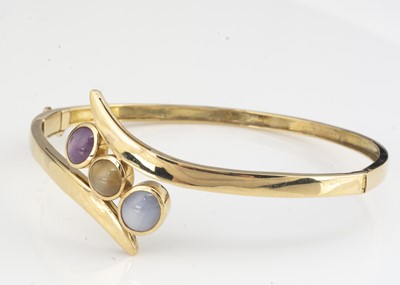 Lot 198 - A continental 14k gem set bangle