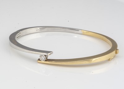 Lot 204 - An 18ct two colour gold diamond hinged bangle