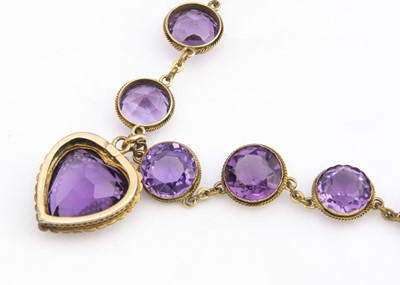 Lot 250 - An Edwardian amethyst and seed pearl heart shaped pendant and chain