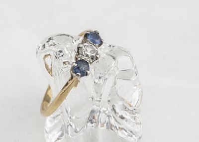 Lot 257 - A three stone diamond and sapphire ring