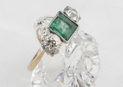 Lot 260 - A three stone emerald and diamond dress ring