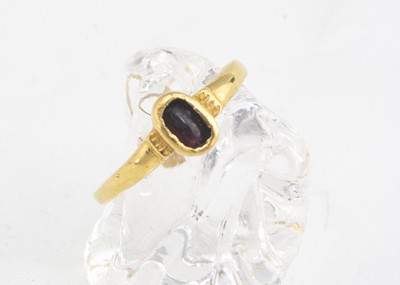 Lot 264 - A medieval garnet and gold posy ring