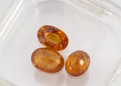 Lot 295 - Three certificated oval mixed cut garnets