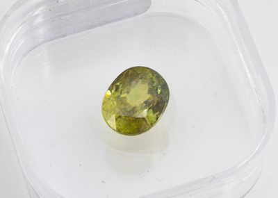 Lot 328 - A certificated oval cut sphene