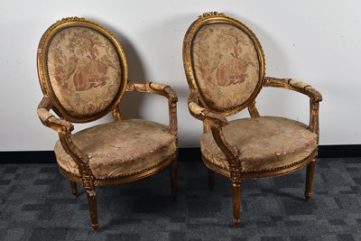 Lot 31 - A pair of French gilt upholstered armchairs