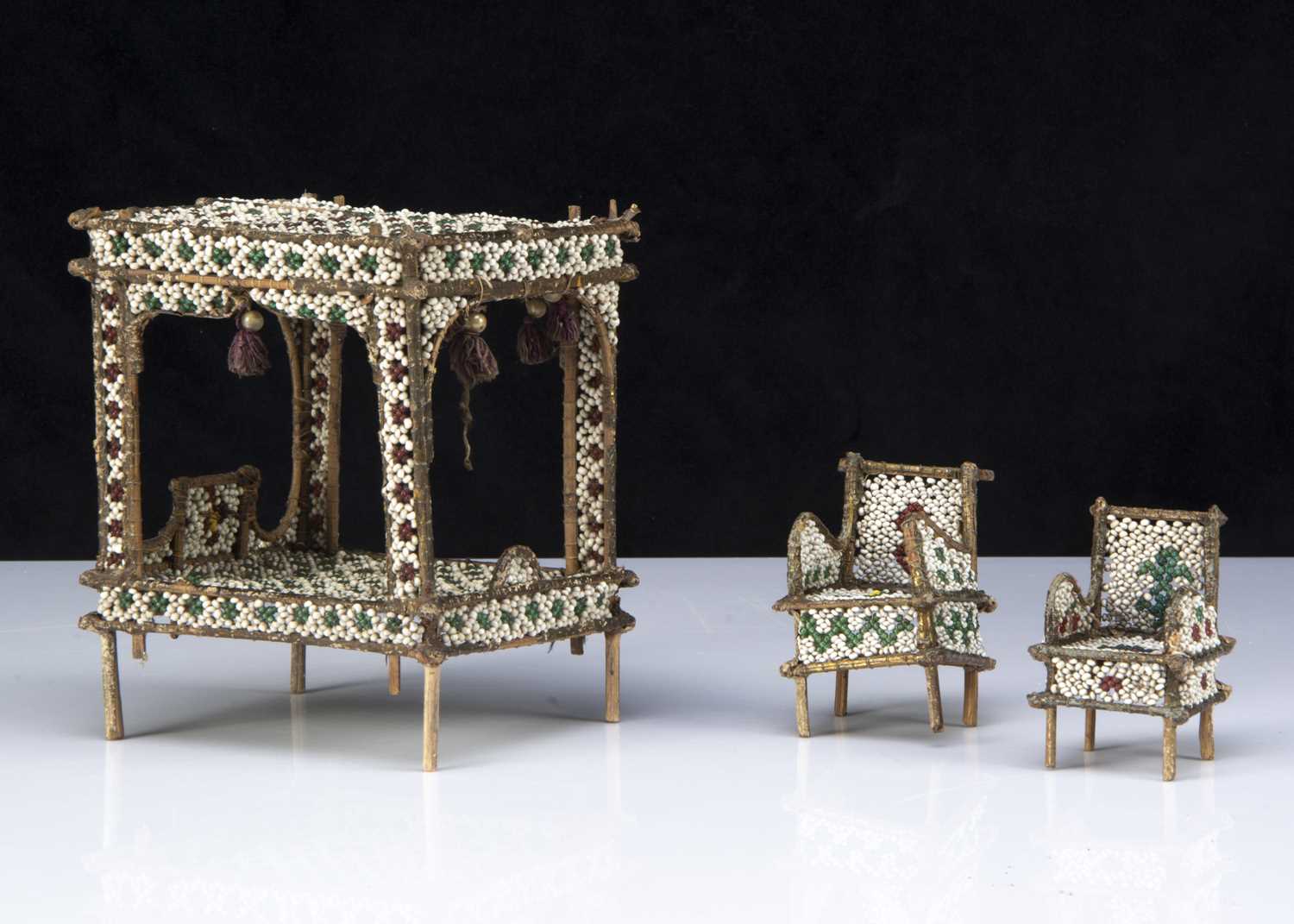 Lot 8 - An unusual glass bead and twig dolls’ house four-poster bed