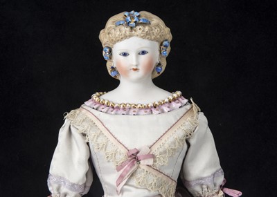 Lot 20 - A rare Kling bisque shoulder-head doll with glass eyes and sculpted dress edge