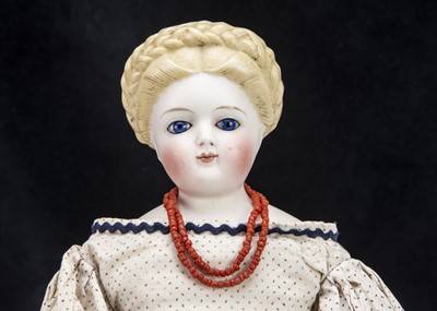 Lot 21 - A rare German bisque shoulder-head doll with glass eyes and elaborate hair