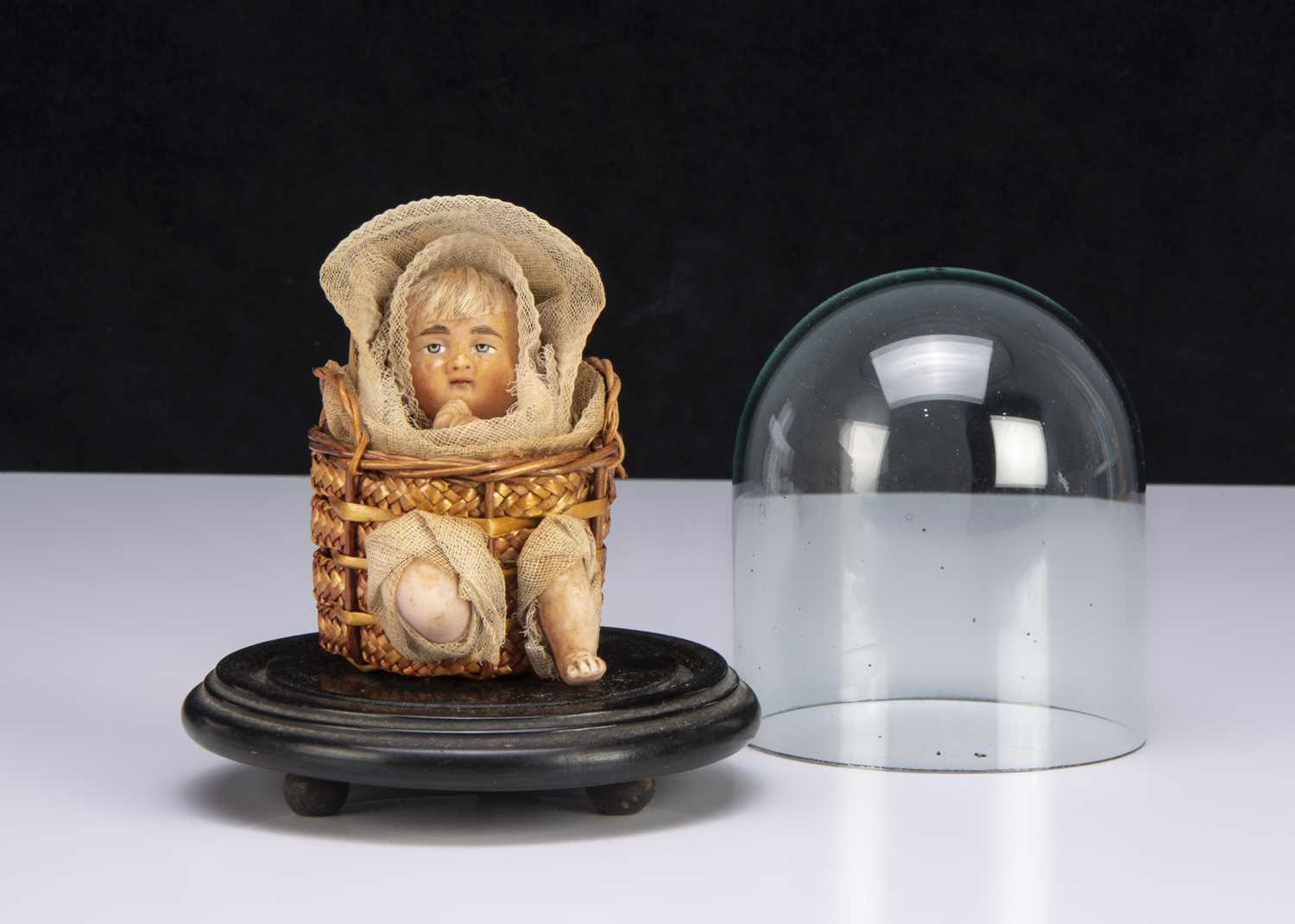 Lot 30 - A German wax baby in a basket candy container