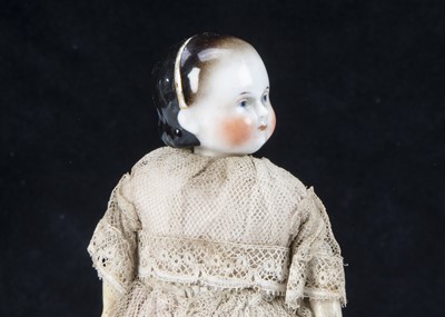 Lot 37 - A small early A.W. Fr Kister china headed young girl doll on taufling body