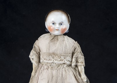 Lot 37 - A small early A.W. Fr Kister china headed young girl doll on taufling body