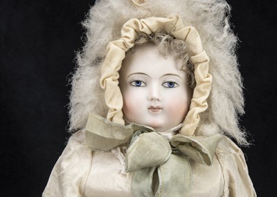 Lot 38 - An unmarked early fashionable doll with solid domed head
