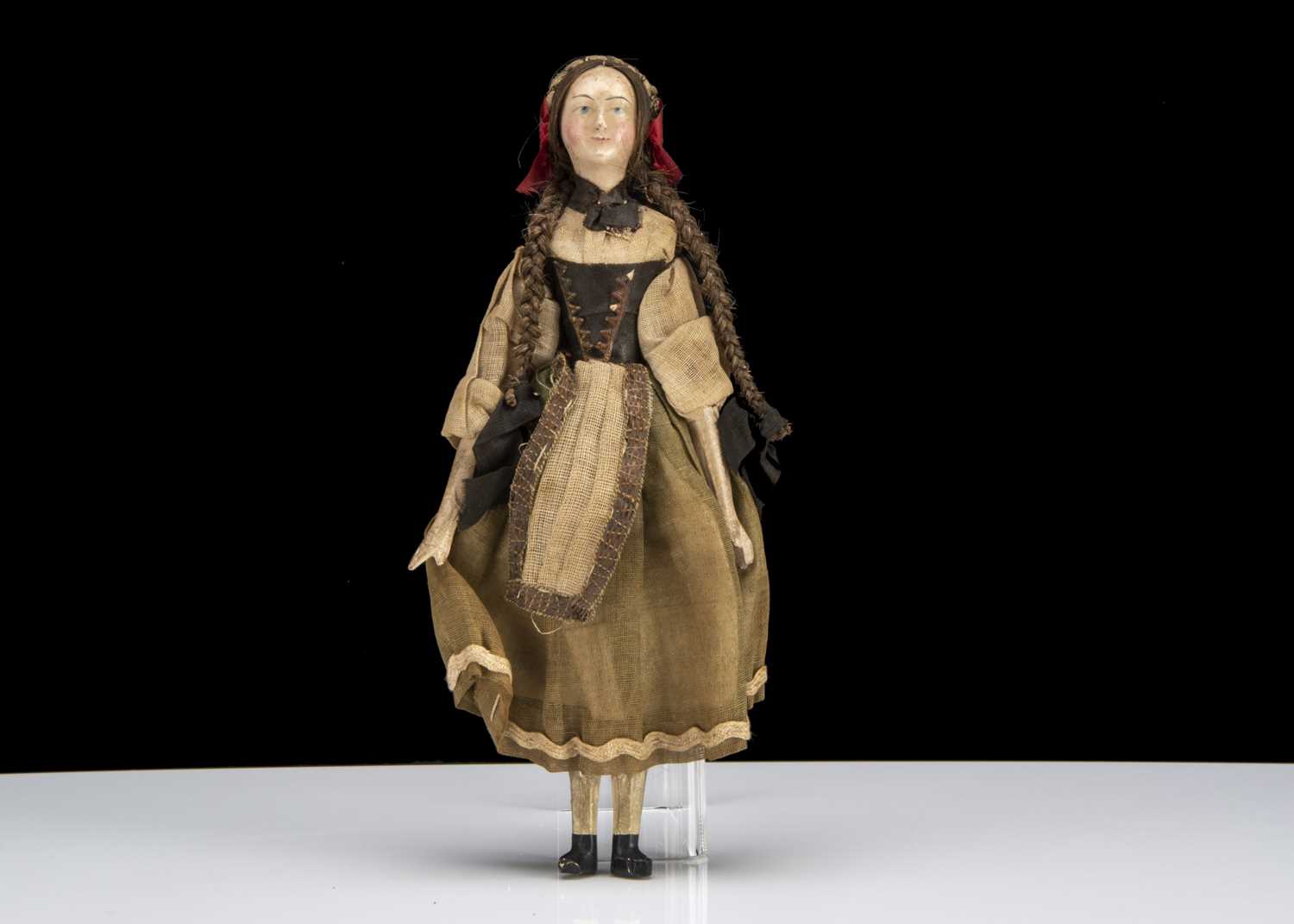 Lot 102 - A small 19th century German composition headed doll with jointed wooden body