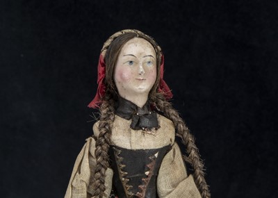 Lot 102 - A small 19th century German composition headed doll with jointed wooden body