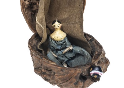 Lot 109 - A 19th century Grodnerthal miniature doll in walnut shell