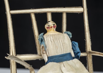 Lot 110 - A 19th century Grodnerthal dolls’ house baby in feather chair