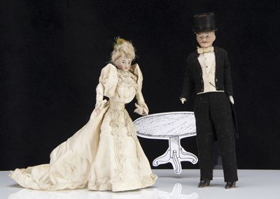 Lot 128 - A German bisque shoulder-headed larger size dolls’ house bride and groom