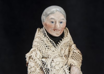 Lot 129 - An unusual German bisque shoulder-head old lady dolls’ house doll