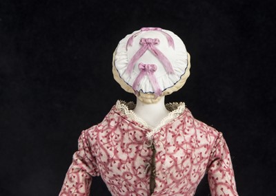 Lot 163 - A rare small German 19th century bisque shoulder head doll with moulded cap