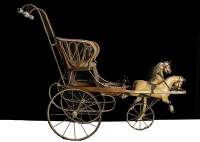 Lot 179 - An early 20th century child’s perambulator with two carved and painted wooden galloping horses