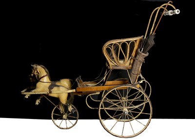 Lot 179 - An early 20th century child’s perambulator with two carved and painted wooden galloping horses