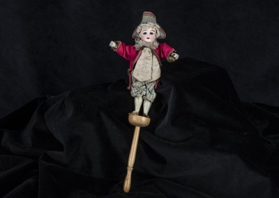 Lot 217 - A bisque headed squeak toy in 18th century costume circa 1900
