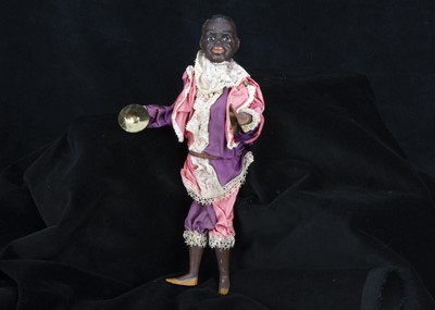 Lot 220 - An unusual painted bisque black man cymbal player