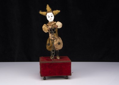 Lot 272 - A late 19th century French white faced clown automaton with magic ring trick