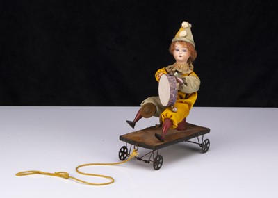 Lot 380 - A pull-a-long clown toy circa 1900