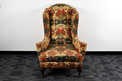 Lot 38 - An early 20th century upholstered wing back armchair