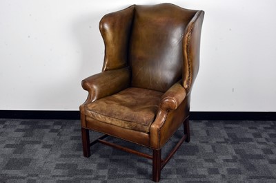 Lot 39 - A George III style leather wing back armchair