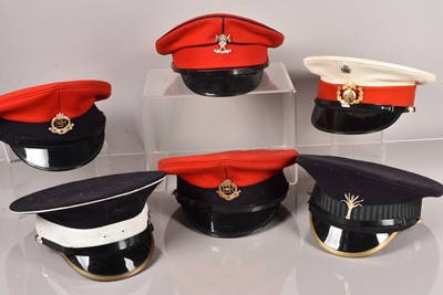 Lot 566 - A collection of Military peak caps