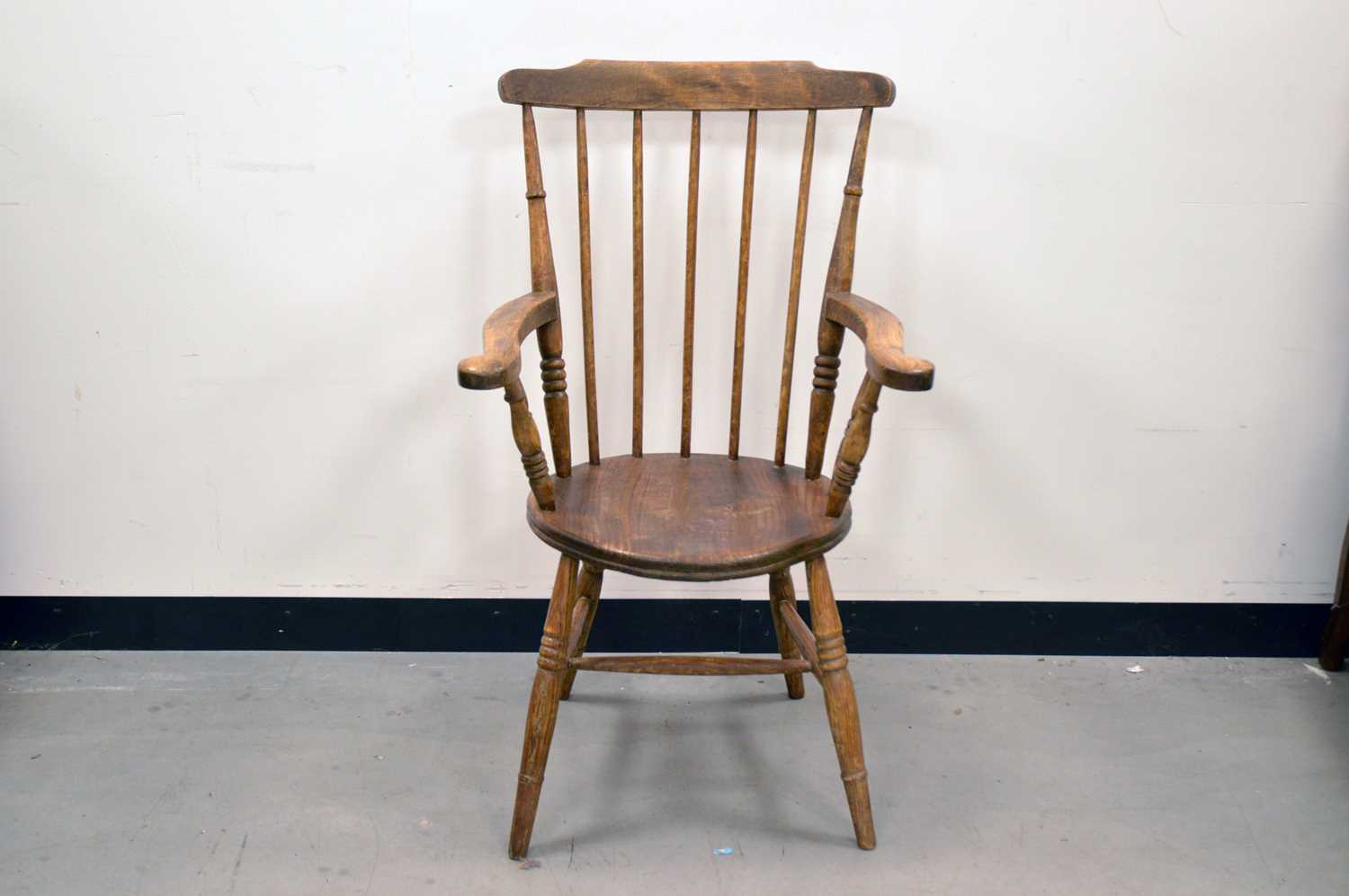 Lot 47 - A 19th century elm stick back armchair