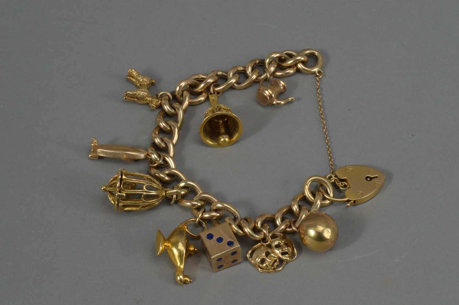 Lot 57 - A 9ct. Gold hollow curbed linked charm bracelet