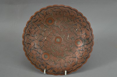 Lot 82 - An Indian copper and silver inlaid small dish