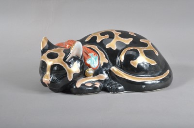 Lot 96 - A late Meiji period Japanese Kutani porcelain recumbent cat