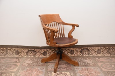 Lot 65 - An Art Deco period oak Captain's style chair by James Philips of Bristol