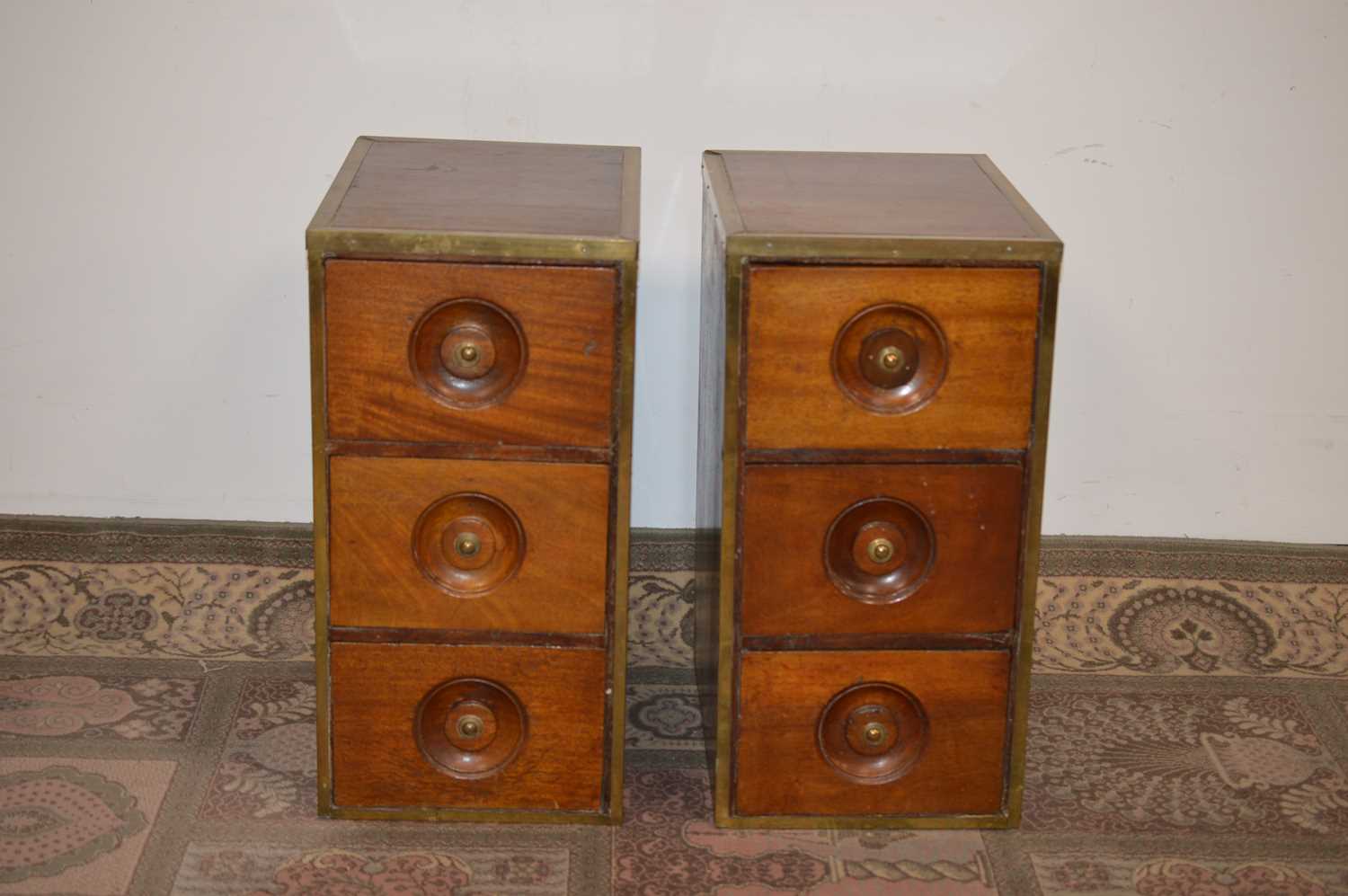 Lot 100 - A pair of early 20th Century brass bound teak bedside tables