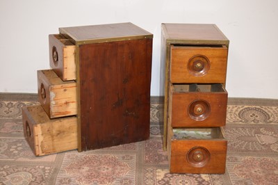 Lot 100 - A pair of early 20th Century brass bound teak bedside tables