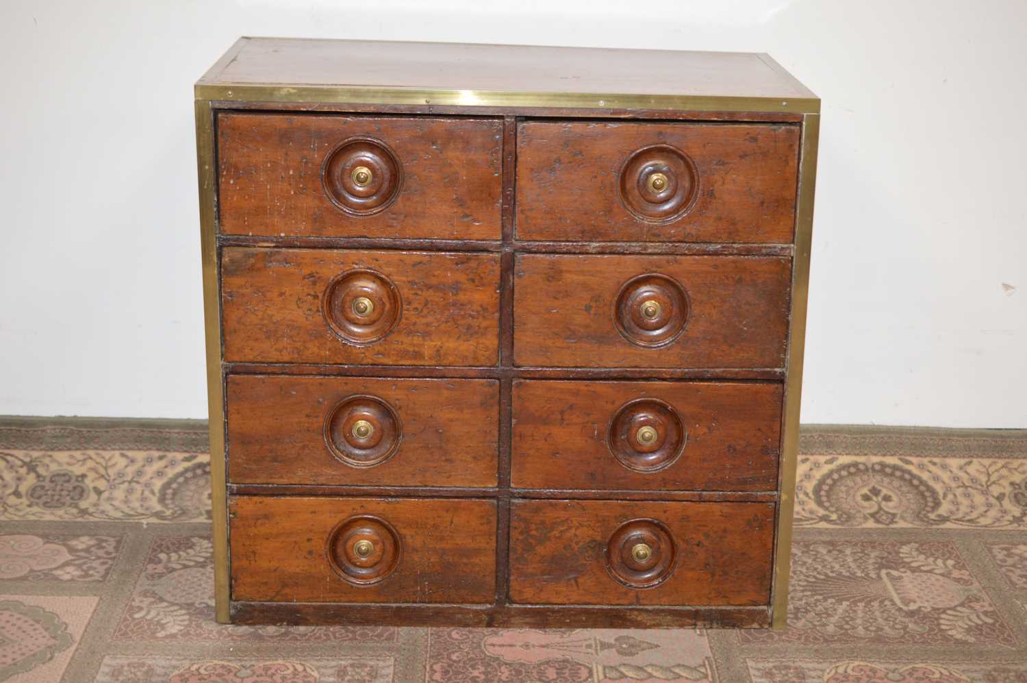 Lot 101 - An early 20th Century brass bound teak chest of drawers