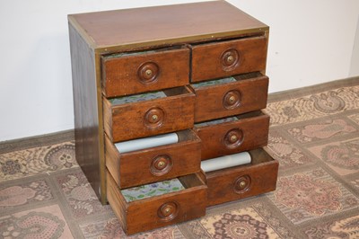 Lot 101 - An early 20th Century brass bound teak chest of drawers