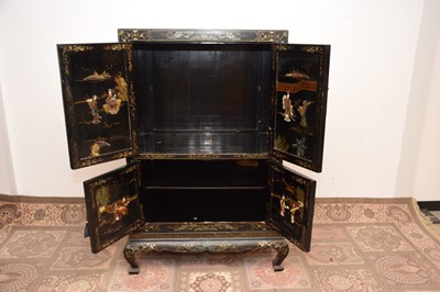 Lot 103 - A late 19th or early 20th century Japanese black lacquer and inlaid cabinet on stand