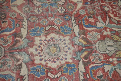 Lot 117 - A large antique hand-knotted wool Heriz carpet