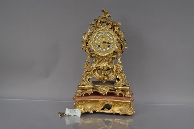 Lot 180 - A Victorian period brass mantle clock on stand