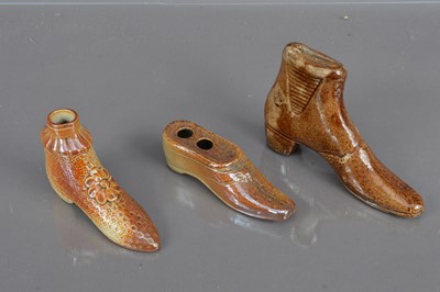 Lot 201 - A group of three 19th Century salt glazed treacleware shoe shape items