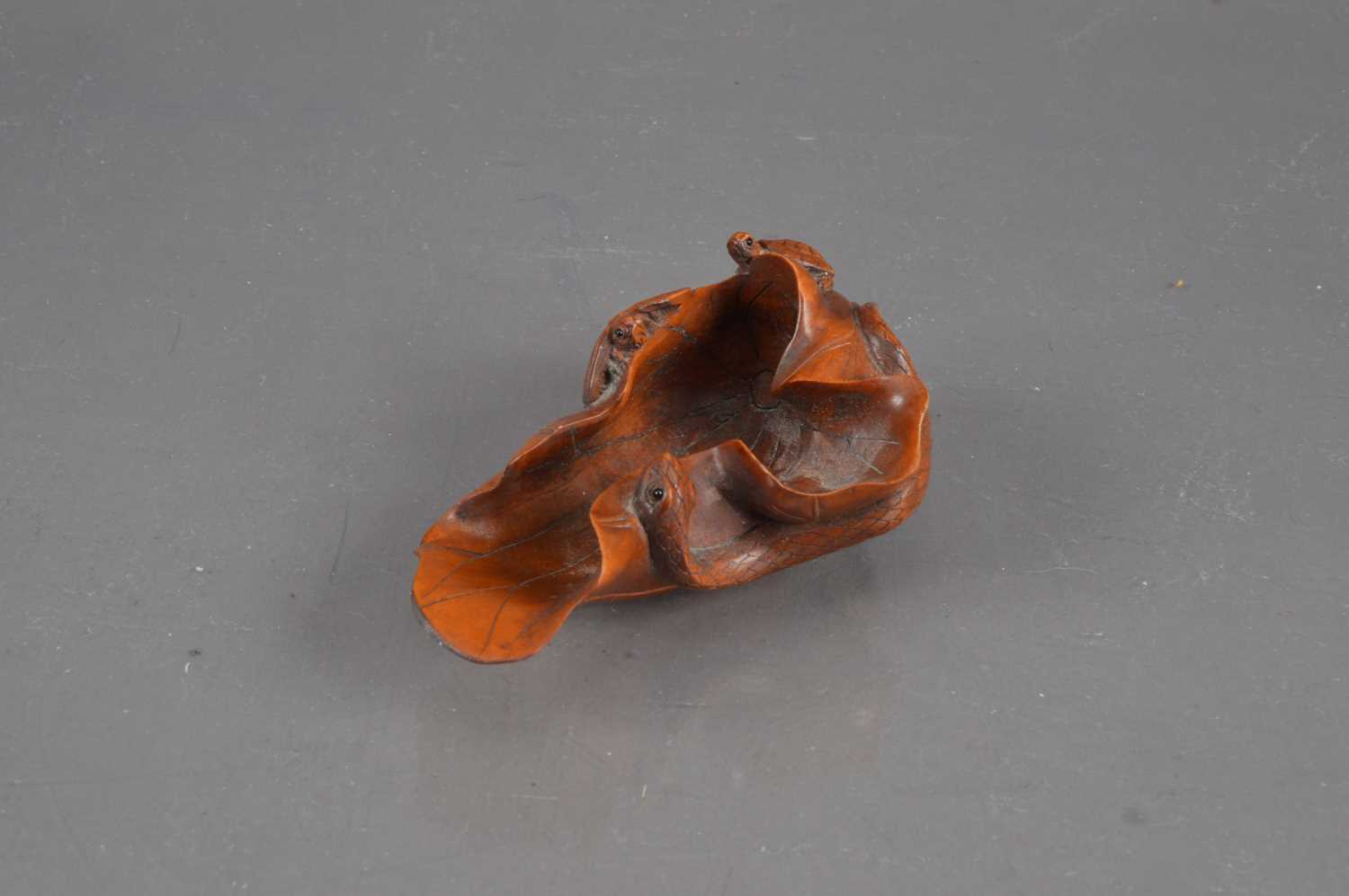 Lot 320 - A Japanese boxwood carving of a lotus leaf