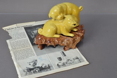 Lot 336 - A Chinese yellow glazed porcelain sculpture group of dogs playing