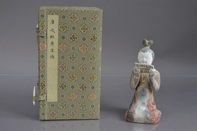 Lot 338 - A Chinese Tang Dynasty style polychrome painted terracotta figure of a kneeling court musician