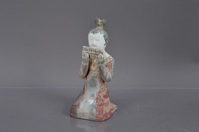 Lot 338 - A Chinese Tang Dynasty style polychrome painted terracotta figure of a kneeling court musician